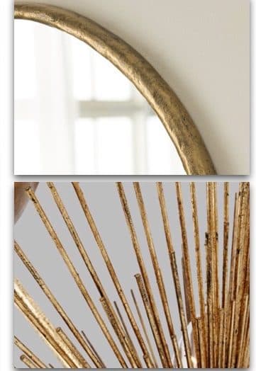 Bathroom material detail with arched mirror and gold-toned wallcovering.