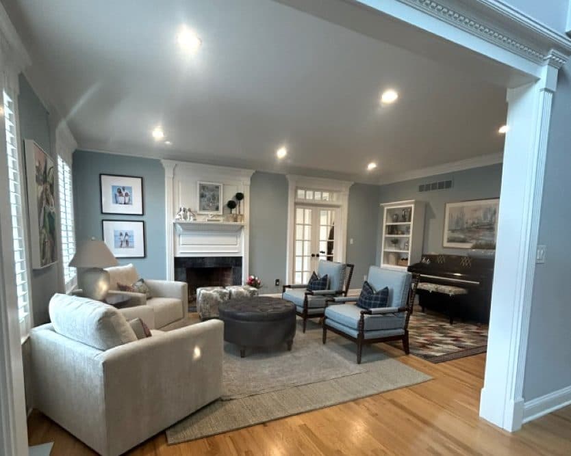 Newtown living room with light seating, fireplace, and open-plan layout.