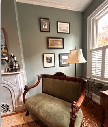 Philadelphia brownstone vignette with antique seating and framed art.