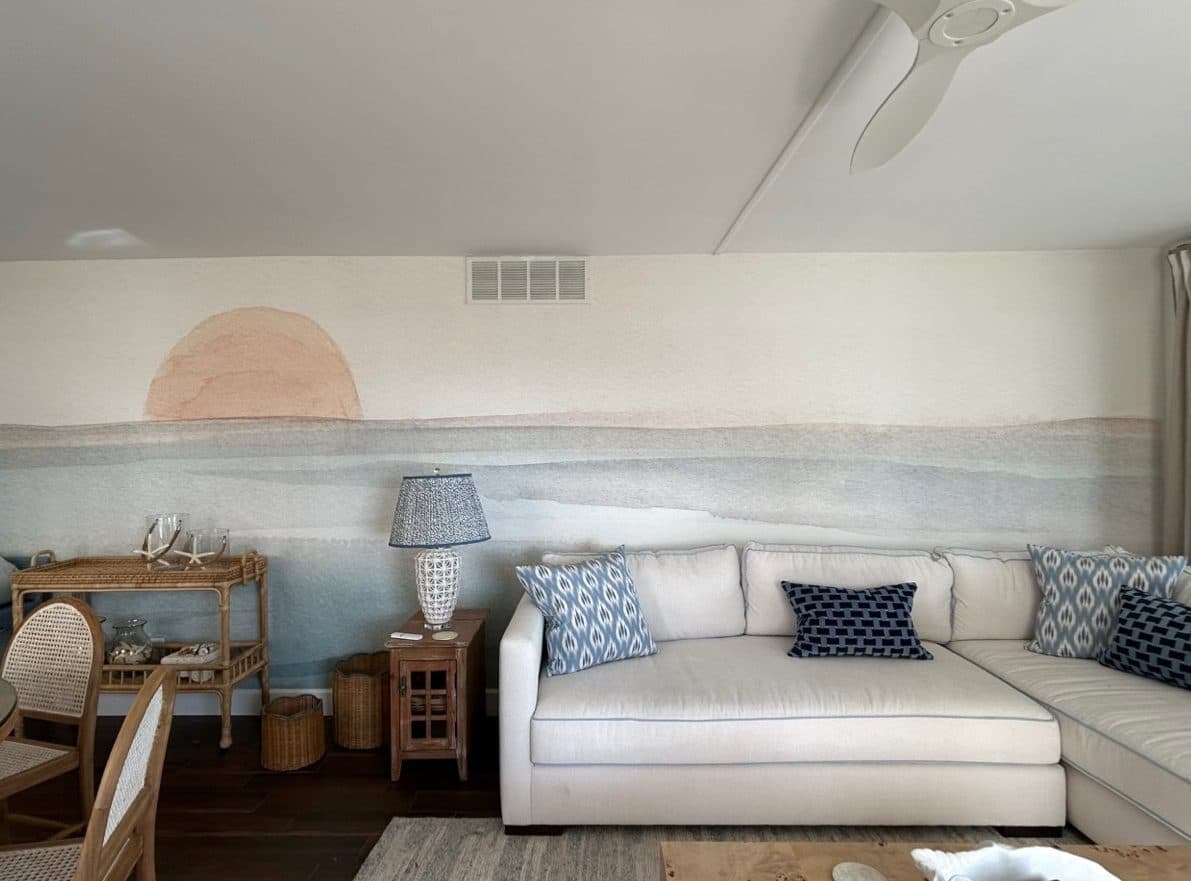 St. Augustine living room with a pale sectional, blue pillows, and soft coastal artwork.