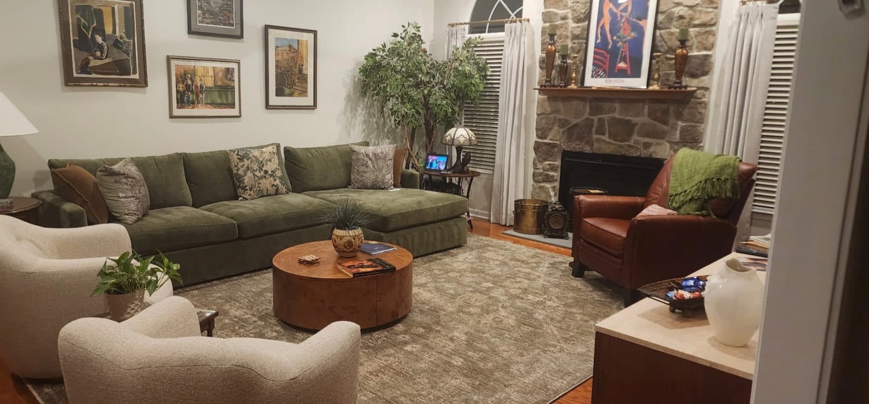 Townhome television room with gray sectional, patterned pillows, and a composed gallery wall.